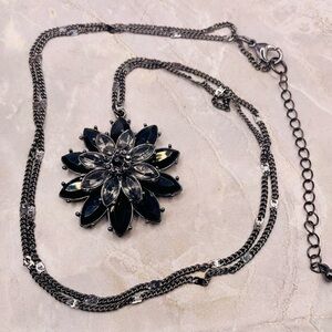 Black and Clear Crystal Flower Pendant on a Gunmetal Tone Necklace. 32 inches